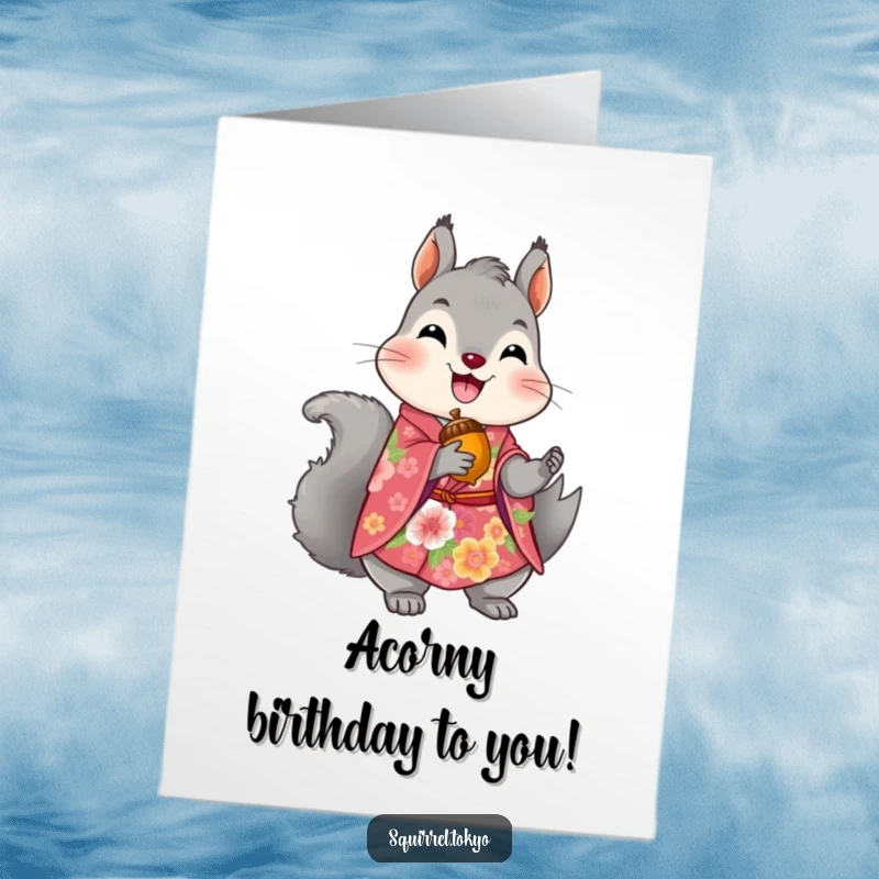 Free Printable Birthday Card: A delighted grey squirrel in a floral kimono holds a golden acorn, wishing you a stylish happy birthday.